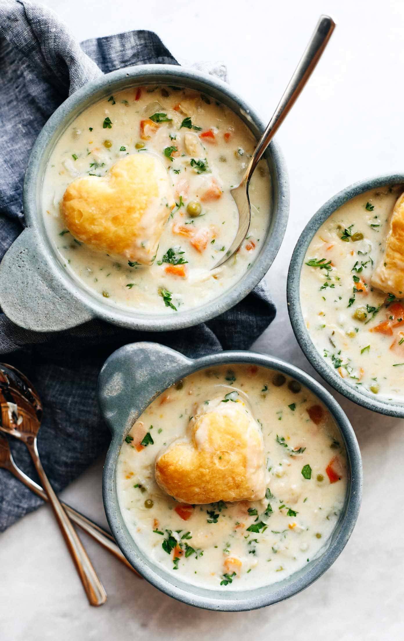Slow Cooker Chicken Pot Pie Soup in bowls with puff pastry hearts.