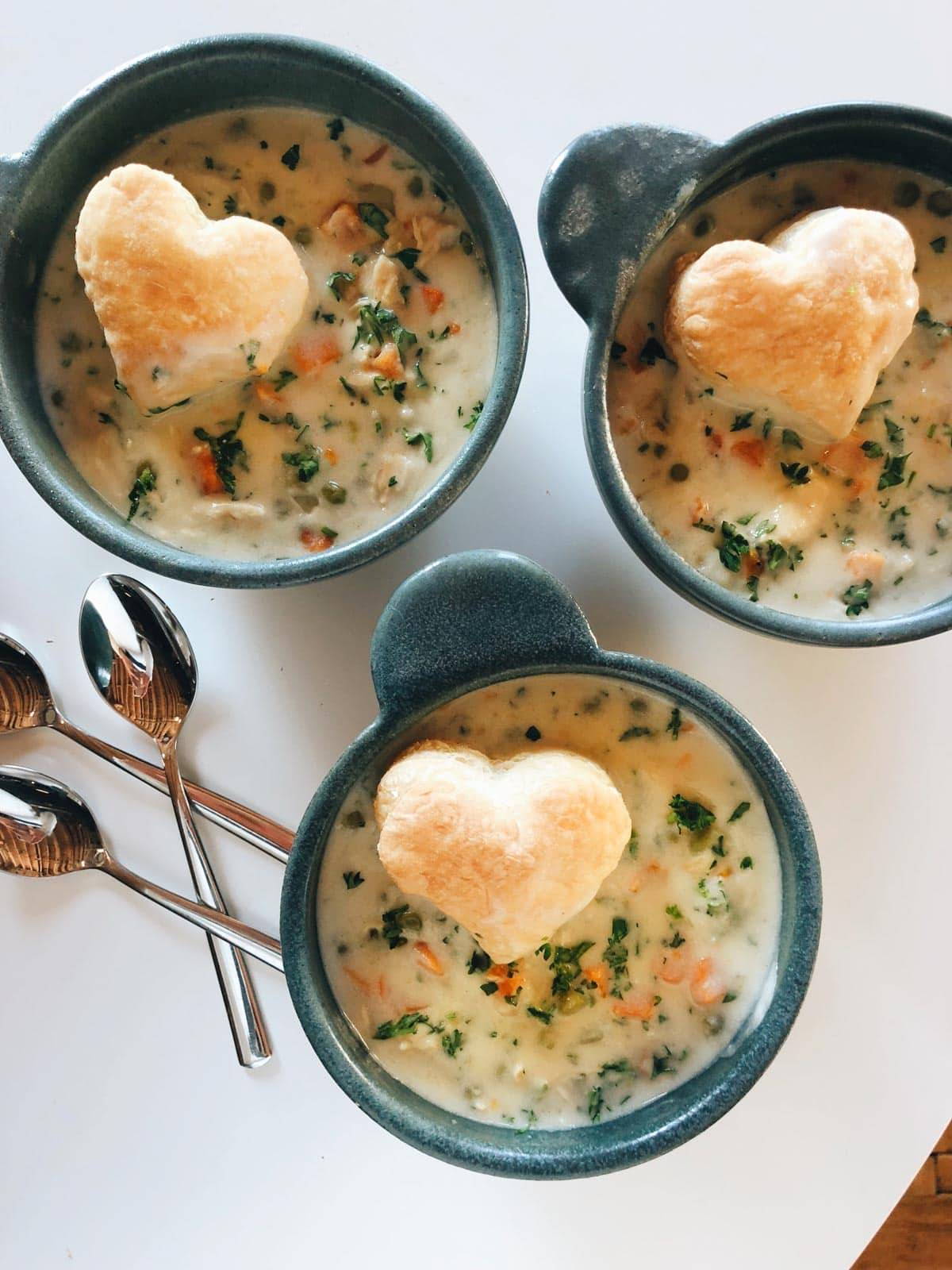 Slow Cooker Chicken Pot Pie Soup in bowls with heart-shaped puff pastry.
