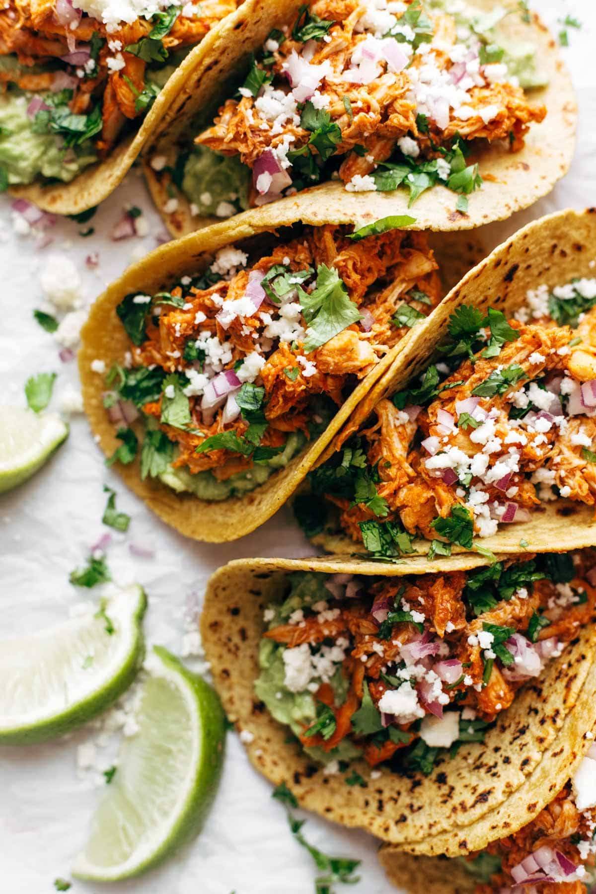 Chicken Tinga Tacos in a row.