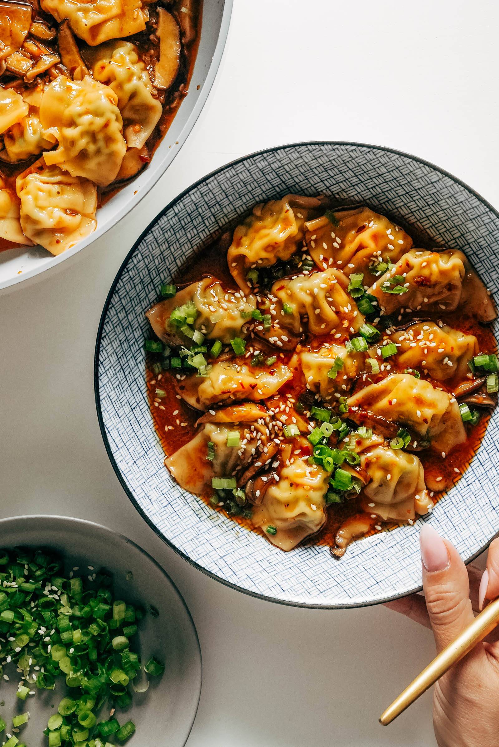 Bowl of chicken wontons in a soup-y broth.