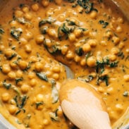 Coconut curry chickpeas with spinach in a pan.