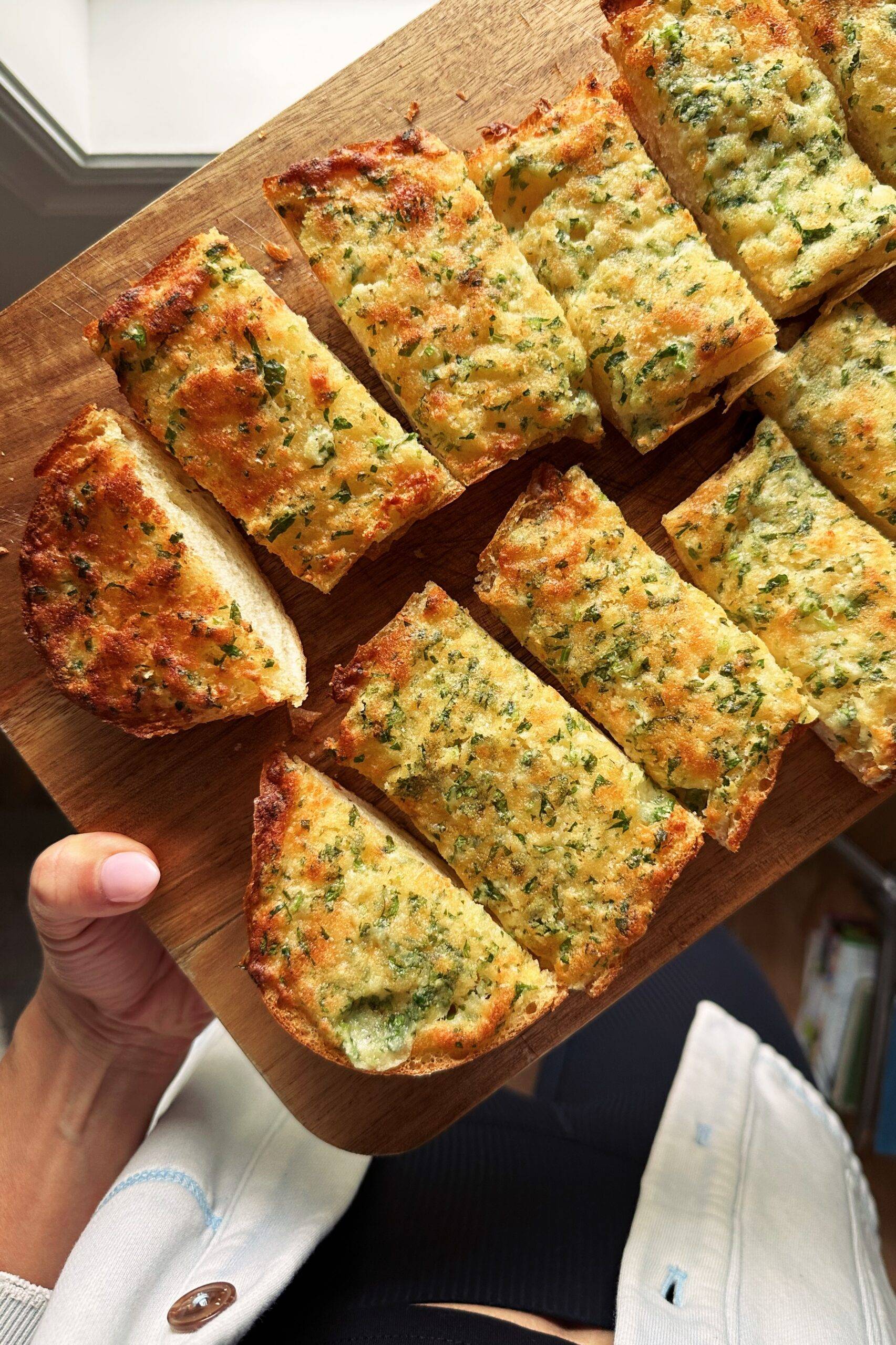 Slices of garlic bread on a cutting board.