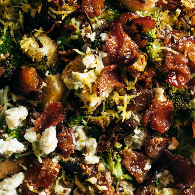 A broccoli salad with with bacon and croutons in it.