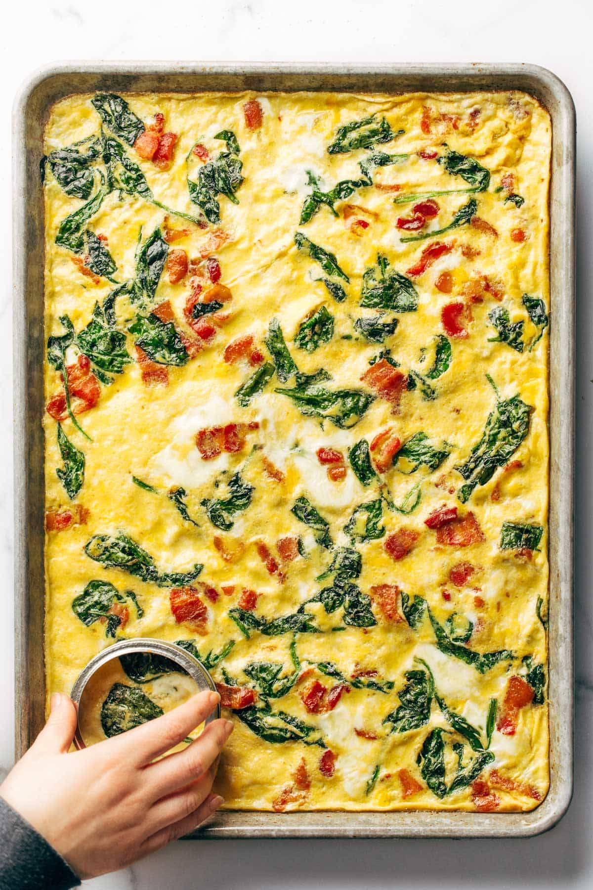Sheet pan eggs with spinach and bacon.