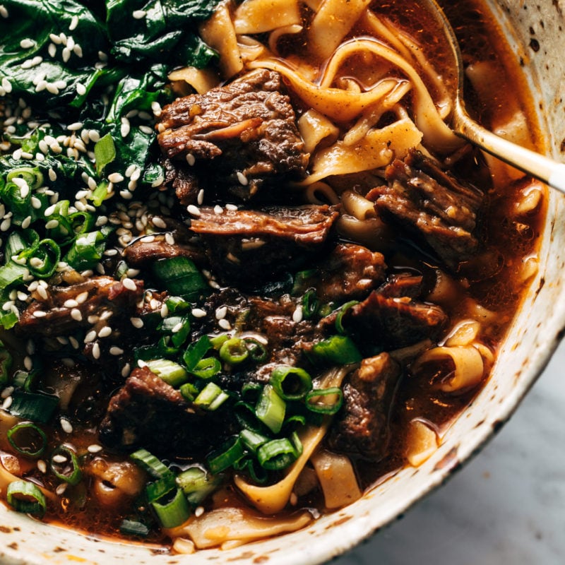 Short rib noodle soup in a bowl with a spoon