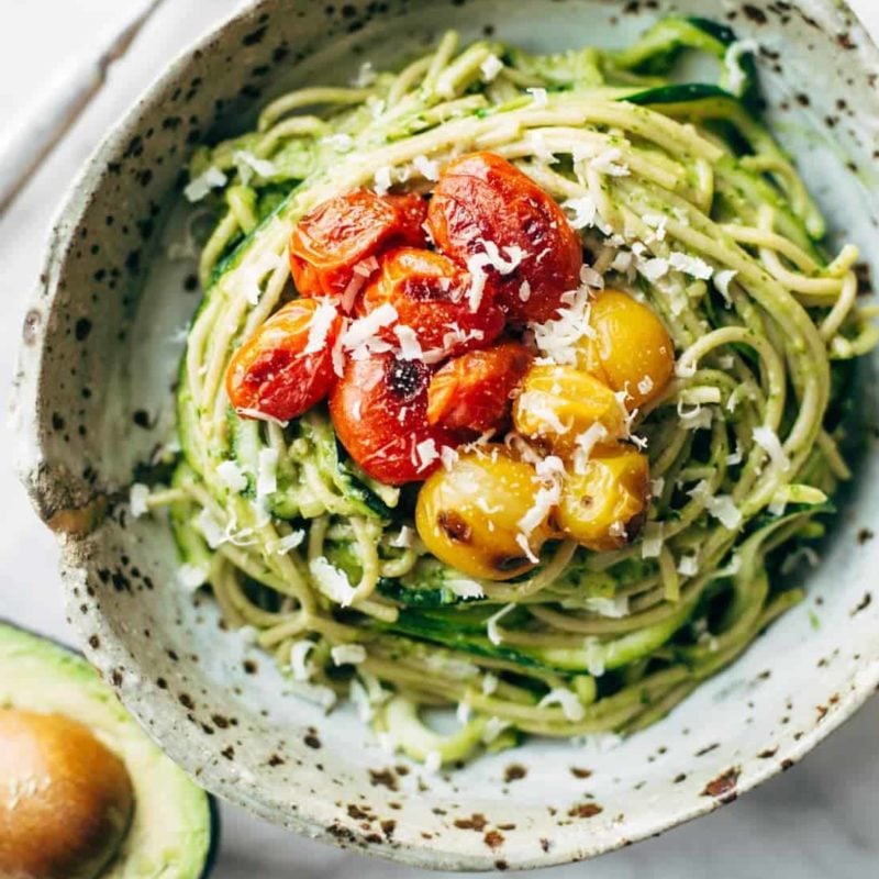 Zucchini spaghetti with tomato topping in a bowl.